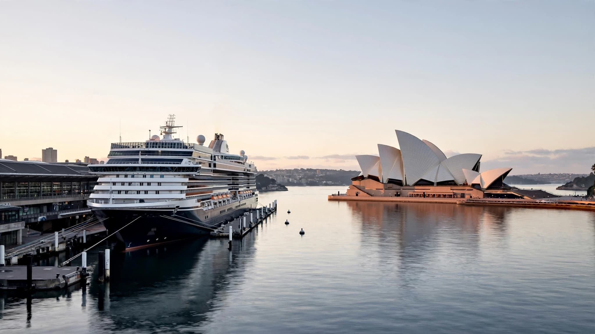 Cruise ship berthed at the Overseas Passenger Terminal on Circular Quay, Sydney Opera House across the harbour at dawn